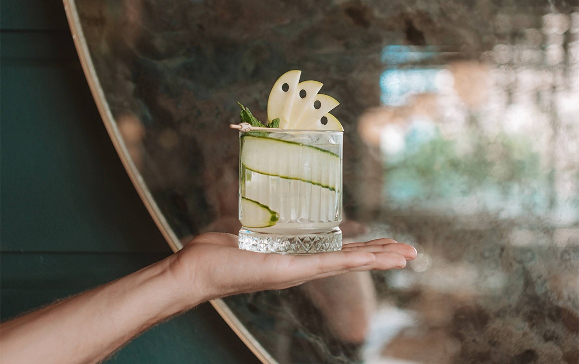 a hand holding a cocktail